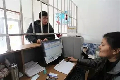 Lhasa Train Station Staff refunding a traveller's per-booked ticket.