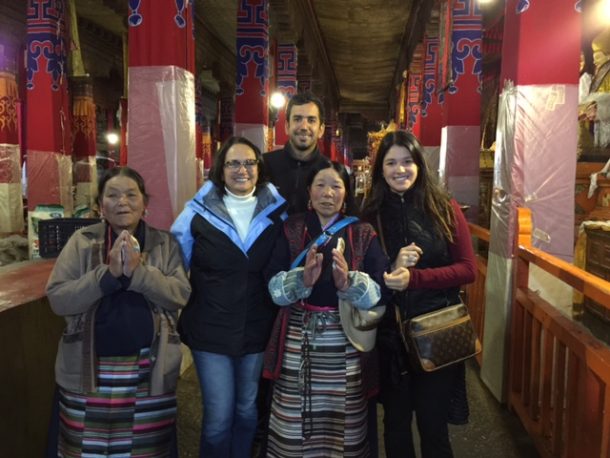 Tibet group tour members photograph with local pilgrims at Drepung monastery