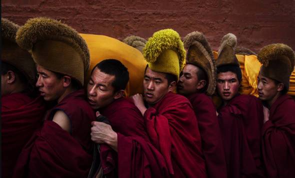 Monks carrying the Thangka on their shoulder during the Festival