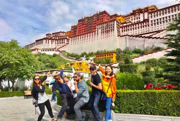 Tourists taking a photo in front of Potala Palace- Explore Tibet