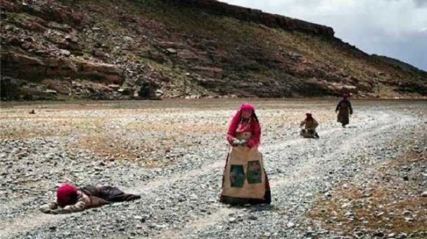 Pilgrims performing prostrations on their ritual spiritual circumambulation of Mount Kailash