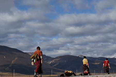 Pilgrims doing Prostration on the road