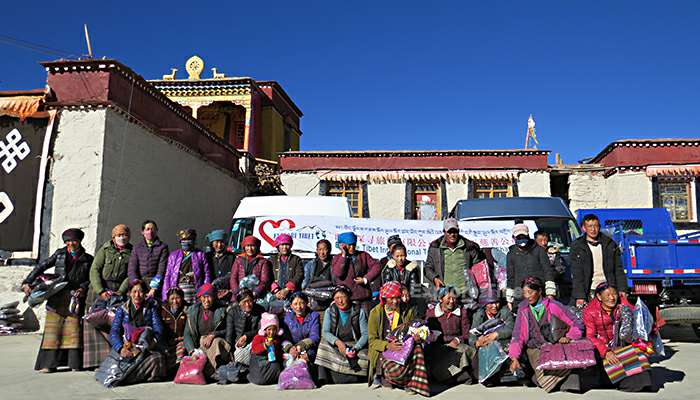 Explore Tibet staff with villagers in poor area