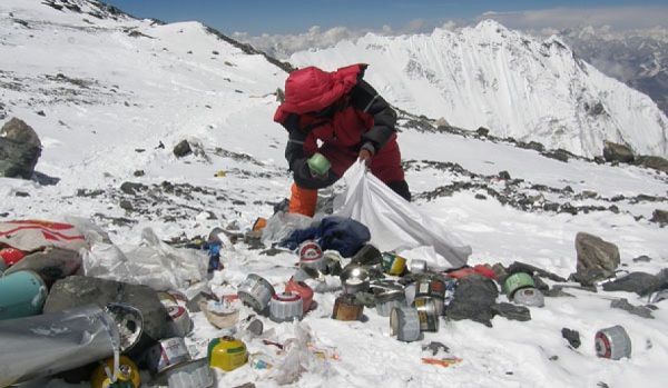 Local herder cleaning the trash on Mount Everest