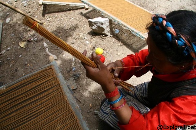 Binding the incense sticks together for packaging ready to be sold.