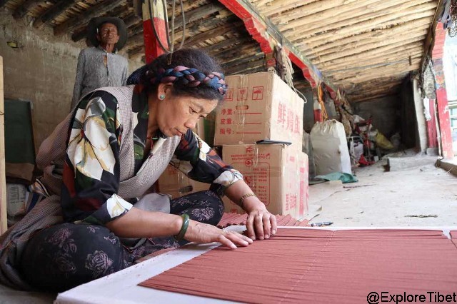 Yangkar, a resident of Thonba Village in Tibet's Nyêmo County, makes incense in her home.